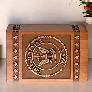 Memorial urn box with US Navy logo silhouette, perfect for cremation ashes.

Personalized US Navy urn box, custom engraved with a Navy logo silhouette.

Handmade wooden urn for ashes, featuring US Navy logo engraving.

Rosewood military urn box, custom engraved with US Navy logo for ashes.

Custom engraved US Navy urn, handcrafted from rosewood for cremation ashes.

Wooden urn with US Navy logo silhouette engraving for ashes of veterans