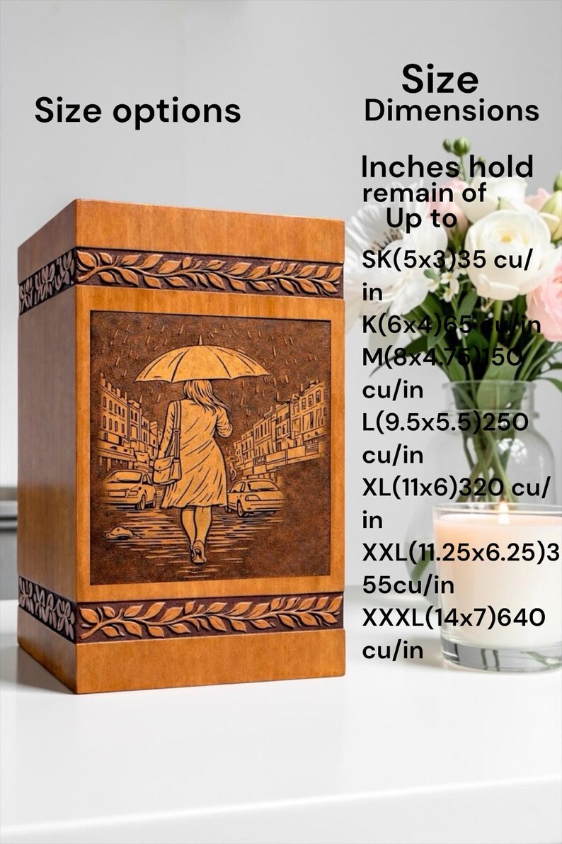 Artistic wooden urn box for human ashes with detailed engraving of a woman walking through a rainy city street under an umbrella. The handcrafted cremation urn includes elegant carved leaf border accents and a polished wood surface, creating a dignified memorial keepsake and tribute for loved ones.