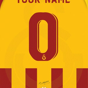 May include: A red and yellow soccer jersey with the number 0 on the front. The jersey has a white logo with the letters "S" and "G" and the number 1905. The text "YOUR NAME" is at the top of the jersey. The text "ALI SAMI YEN STADYUMU" is at the bottom of the jersey, along with the coordinates "41.103 N 28.991 E", the capacity "52.223", and the year "2011".