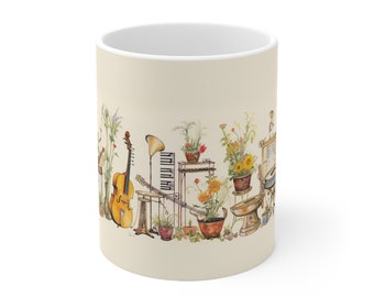 May include: A cream-colored ceramic mug featuring a detailed watercolor illustration of various musical instruments, including a cello and piano keys, interspersed with potted plants, sunflowers, and tall grasses arranged in a continuous wrap-around design.