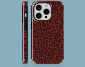 May include: A maroon phone case with a leopard print design. The case is shown from the front and side, showcasing the camera cutouts and the textured pattern. The case is designed to protect the phone while adding a stylish flair.