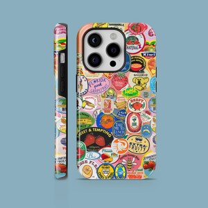 May include: A colourful phone case featuring a variety of fruit-themed stickers and labels. The case is decorated with a bright pink, yellow and blue colour scheme and features a variety of fruits, including strawberries, bananas and oranges. The case also features the text "Take Me To Lunch" and "Extra Fruity".