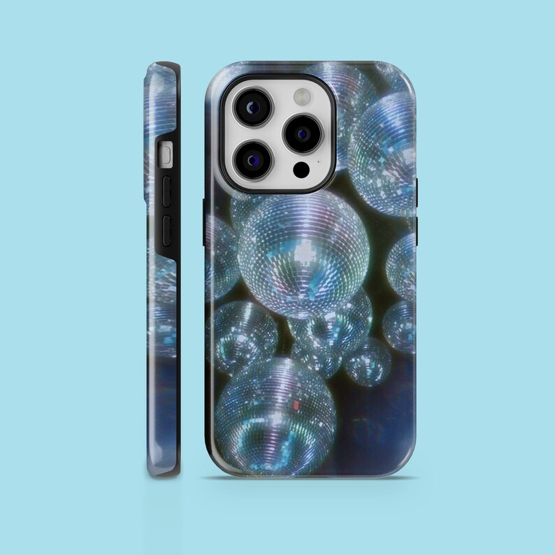 May include: A black phone case with a design of silver disco balls on a dark blue background.