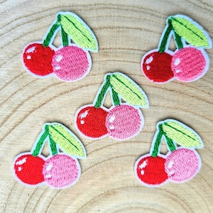 May include: Five embroidered iron-on patches of cherries. Each patch features two cherries with green stems and leaves. The cherries are red and pink.