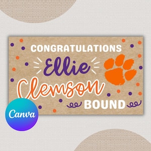 May include: A rectangular sign with a kraft paper background. The sign features the words "CONGRATULATIONS Ellie Clemson BOUND" in orange and purple. An orange paw print and polka dots are also included.