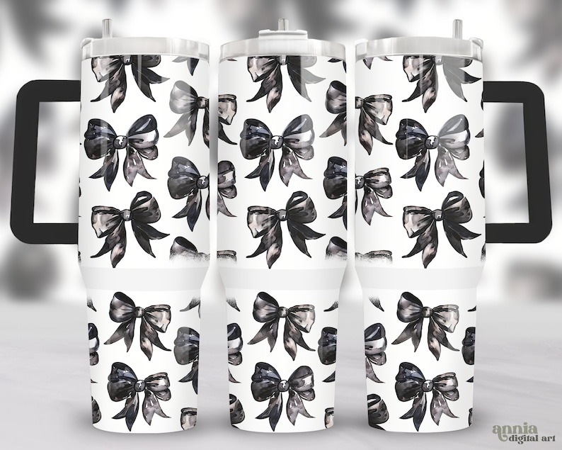 May include: Three stainless steel tumblers with a black and white watercolor bow pattern. The tumblers have a lid and a handle.