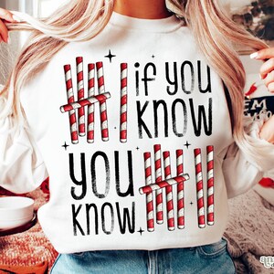 May include: White sweatshirt with the text "if you know, you know" in black. The design includes red and white candy cane graphics. The sweatshirt is a casual, comfortable style.