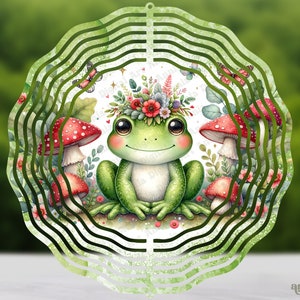 May include: A green frog with a flower crown sits in a whimsical garden setting. The frog is surrounded by red and white mushrooms, green leaves, and butterflies. The image is designed for a metal wind spinner.