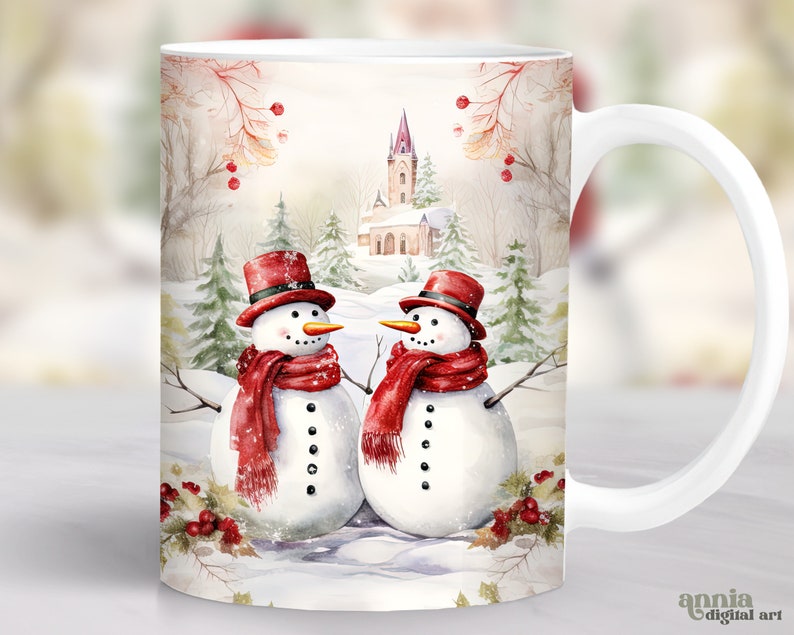 May include: White ceramic mug with a winter scene featuring two snowmen wearing red scarves and hats. The background includes a church, trees, and snow.