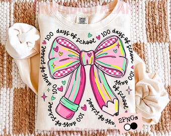 May include: Cream-colored sweatshirt with a large, colorful graphic of a bow and pencil. The bow is pink, green, and yellow with a checkered pattern. The text "100 days of school" surrounds the bow. A fun, back-to-school themed design.