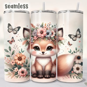 May include: A white stainless steel tumbler with a fox wearing a floral crown and surrounded by butterflies and flowers. The tumbler has a pink, white, and green floral design.