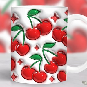 May include: White ceramic mug featuring a red and green cherry design. The cherries are glossy and have a 3D effect. The mug has a white handle.