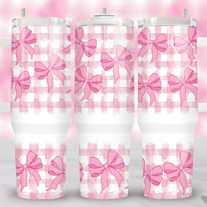 May include: White tumbler with a pink and white gingham pattern and pink watercolor bows. The tumbler has a lid and a handle.