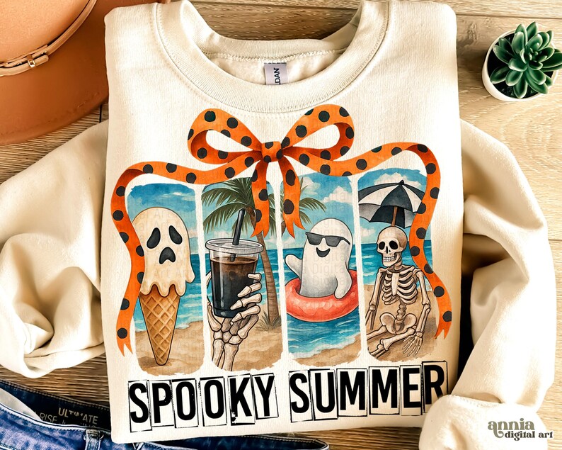 May include: Cream-colored sweatshirt with a "Spooky Summer" graphic. The graphic features a ghost ice cream cone, a skeleton holding a drink, and a ghost in a floatie on a beach scene. An orange bow with black polka dots frames the design.