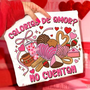 May include: White t-shirt with a colorful graphic design featuring various sweets, hearts, and the text "CALORIAS DE AMOR? NO CUENTAN" in pink. The design includes a drink, churros, and a slice of cake.