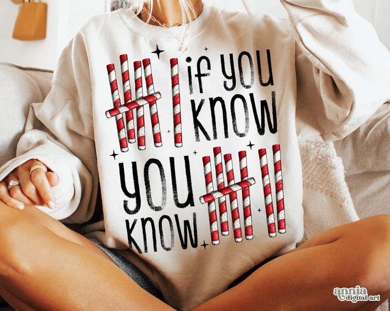 May include: Cream-colored sweatshirt with the text "If You Know, You Know" in black. The design includes red and white candy cane graphics and small black star accents, creating a festive holiday theme.
