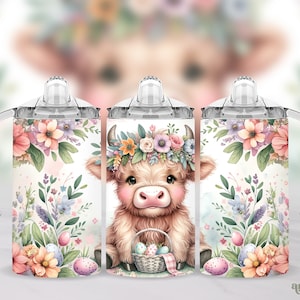 May include: A white tumbler with a floral design and a cute cartoon cow wearing a flower crown and holding a basket of Easter eggs. The tumbler has a clear lid and a handle.
