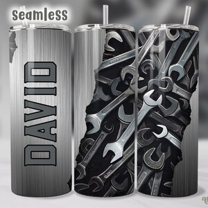 May include: A stainless steel tumbler with a black and gray design. The tumbler features the name "DAVID" in bold, gray letters. The design includes a collection of wrenches. The word "seamless" is at the top.