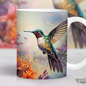 May include: White ceramic mug featuring a colourful hummingbird in flight against a backdrop of abstract floral designs. The hummingbird has green, blue, and yellow feathers. The flowers are orange, purple, and white.