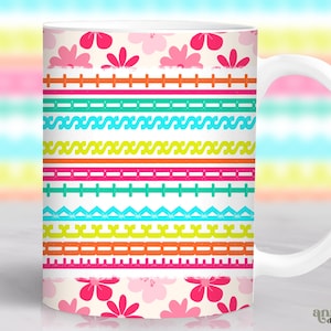 May include: White ceramic mug with a colorful floral and geometric pattern. The design features pink flowers, and horizontal bands in various colors including pink, green, orange, and blue. The mug has a white handle and the words "annia digital art" are visible.