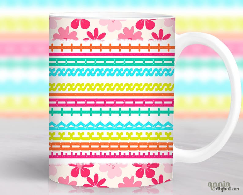 May include: White ceramic mug with a colorful floral and geometric pattern. The design features pink flowers, and horizontal bands in various colors including pink, green, orange, and blue. The mug has a white handle and the words "annia digital art" are visible.