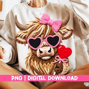 May include: A white sweatshirt featuring a detailed illustration of a Highland cow. The cow has brown fur, a pink bow, heart-shaped sunglasses, and a red heart lollipop. The text "PNG | DIGITAL DOWNLOAD" is displayed in pink.
