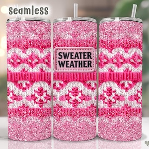 Puede incluir: Tres vasos de vaso de color rosa y blanco con purpurina con un diseño de clima de suéter. El vaso del medio tiene un parche blanco y negro que dice "Sweater Weather".