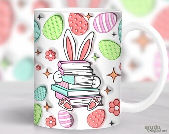 May include: White ceramic mug with a colorful Easter bunny design. The bunny is holding a stack of books and is surrounded by colorful Easter eggs. The mug has a handle and is perfect for hot beverages.