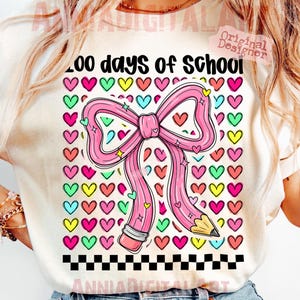 May include: A light-colored t-shirt featuring a large pink bow and pencil design with the text "200 days of School". The design includes colorful hearts and a black and white checkered border, perfect for celebrating the school year.