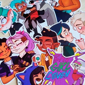 May include: A selection of colourful stickers depicting cartoon characters. The stickers show various characters in dynamic poses, with a vibrant colour palette. Some stickers include text, such as "BAD GIRL COVEN".