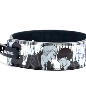 May include: Black leather belt with a white and grey print of two characters from a manga. The belt buckle is black with the text "LAST KINGS" in white.