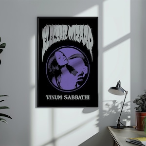 May include: A rectangular black poster featuring the text Electric Wizard in a jagged white font at the top. A purple circular graphic in the center depicts a person with long hair holding a snake. The text Vinum Sabbathi appears in white below.