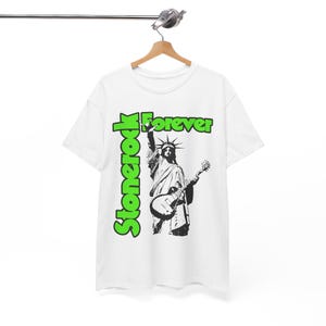 May include: White t-shirt featuring a black and white graphic of the Statue of Liberty playing a guitar. The words "Stonerock" in green are vertically aligned on the left, with "Forever" in green above the statue.