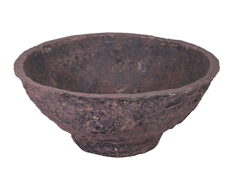 May include: A rustic, brown bowl with a textured surface. The bowl has a wide, open top and a slightly rounded base. The color is a deep, earthy brown with variations in tone, suggesting a natural, handcrafted appearance. The bowl is likely used for serving or display.