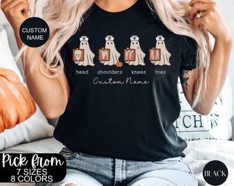 May include: Black t-shirt with a graphic of four ghosts dressed as nurses holding x-rays. The ghosts are labeled "head", "shoulders", "knees", and "toes". The text "Custom Name" is printed below the ghosts.