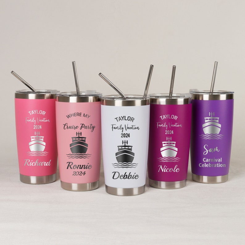 May include: Five stainless steel tumblers with personalized text and a cruise ship graphic. The tumblers are in various colors, including pink, white, purple, and a dark purple. Each tumbler has a straw.