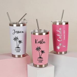 May include: Three stainless steel tumblers with lids and straws. One is white with "Jessica" and a palm tree graphic, another is pink with "Karla", and the third is pink with "Calida". All have "Cancun 2024" text.