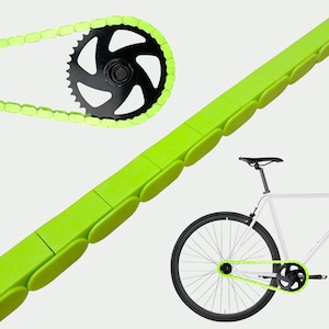 May include: Bright green bicycle chain and chain guard set. The chain is paired with a black sprocket. A white bicycle with black wheels and a green chain is also shown.