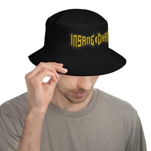 May include: Black bucket hat with a gold embroidered logo that says "INSANE CHAIN".