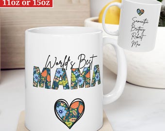 May include: White ceramic mug with a floral design and the text "World's Best Mama". The mug has a heart with a floral design at the bottom. The mug is available in 11oz or 15oz sizes.