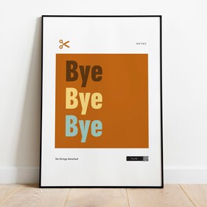 May include: A framed poster with a white background and a brown square in the centre. The square has the text "Bye Bye Bye" in brown, yellow, and blue. The text "NSYNC" is in black at the top right corner of the poster. The text "No Strings Attached" is at the bottom left corner of the poster.