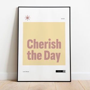 May include: A framed poster with a yellow background and the text "Cherish the Day" in pink. The poster also includes a small sun icon and the text "Sade" and "Love Deluxe".