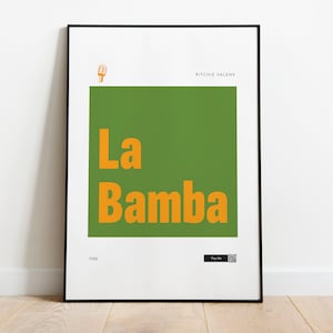 May include: A black framed poster with a green background and the text "La Bamba" in orange. The artist's name, "Ritchie Valens", is printed in black at the top of the poster.
