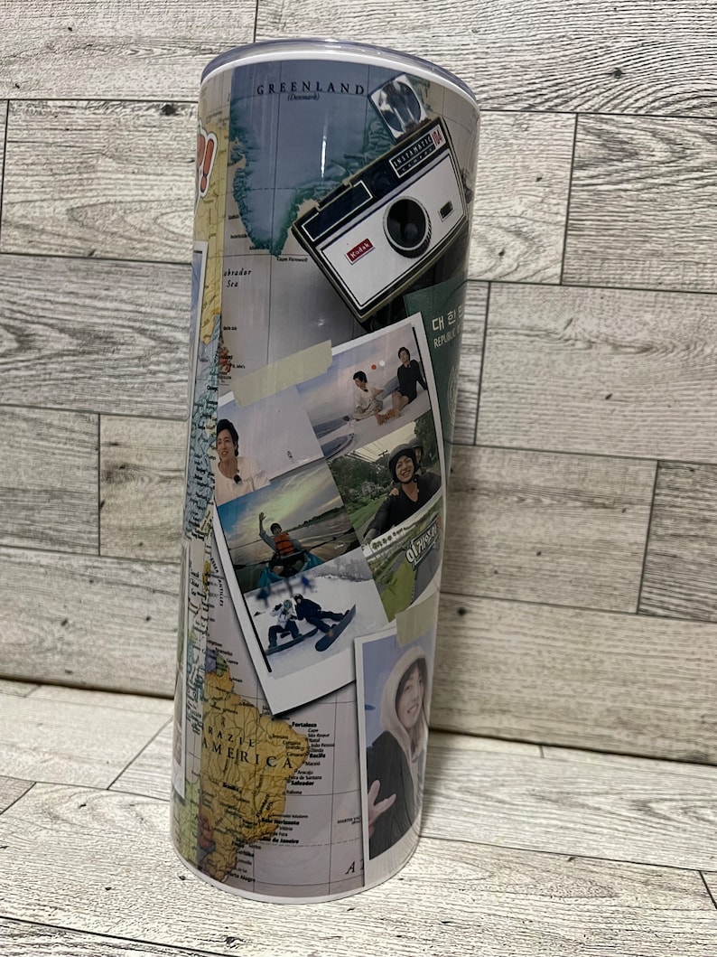 May include: A stainless steel travel tumbler with a collage of photos and a world map design. The photos include a vintage camera, a group of people on a beach, a person snowboarding, and a person standing in front of a mountain. The map shows South America, North America, and Greenland.