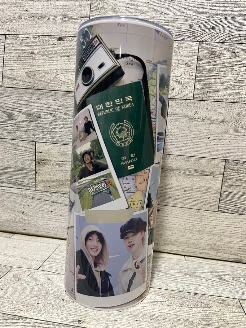 May include: A white travel tumbler with a collage of images, including a passport, a camera, and photos of people. The text "대한민국 REPUBLIC OF KOREA" is visible on the passport.