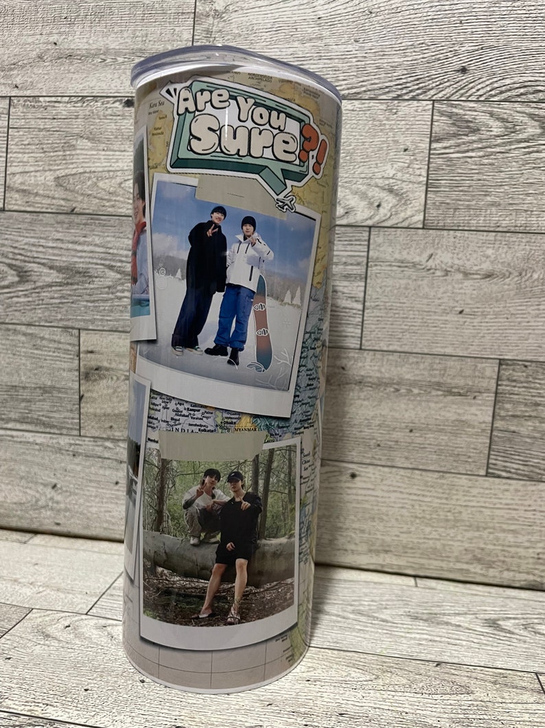 May include: A white travel mug with a collage of photos and a sticker that says "Are You Sure?" The photos show two people in different settings, including a snowy landscape and a forest.