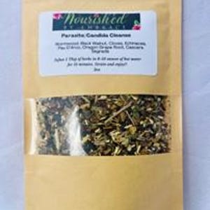 May include: A brown paper bag with a clear window showing a blend of dried herbs labeled "Parasite Candida Cleanse" with ingredients listed: Wormwood, Black Walnut,  Cloves,  Garlic,  Pau D'Arco, Oregon Grape Root,  Ginger,  and  Cayenne.  Take 1 tbsp of herbs in 8 oz of hot water for 10 minutes, strain and enjoy!