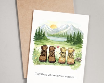 May include: Greeting card with a watercolor illustration of four hiking boots in a field with a mountain landscape background. The text "Together, wherever we wander" is printed below the boots. A brown envelope is behind the card.