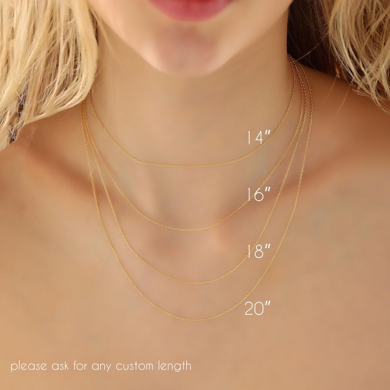 May include: Four delicate gold necklaces of varying lengths, 14, 16, 18, and 20 inches, are displayed around a person's neck. The image shows the necklaces' different lengths. The text at the bottom says, "please ask for any custom length."