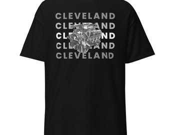 May include: Black t-shirt with the word "CLEVELAND" stacked vertically in a light gray font. A detailed grayscale image of an engine is centered on the shirt.